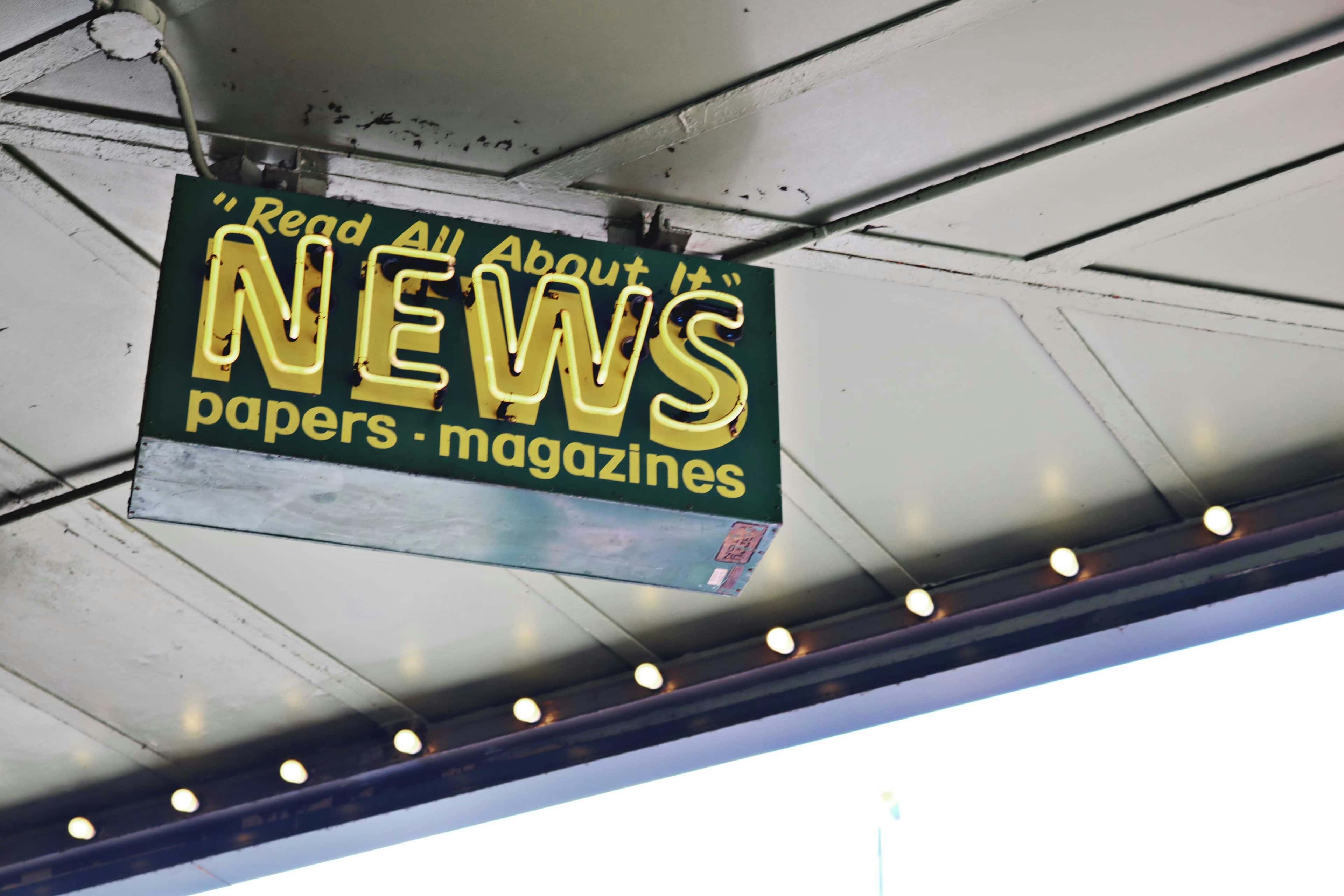 A shop sign advertising newspapers and magazines