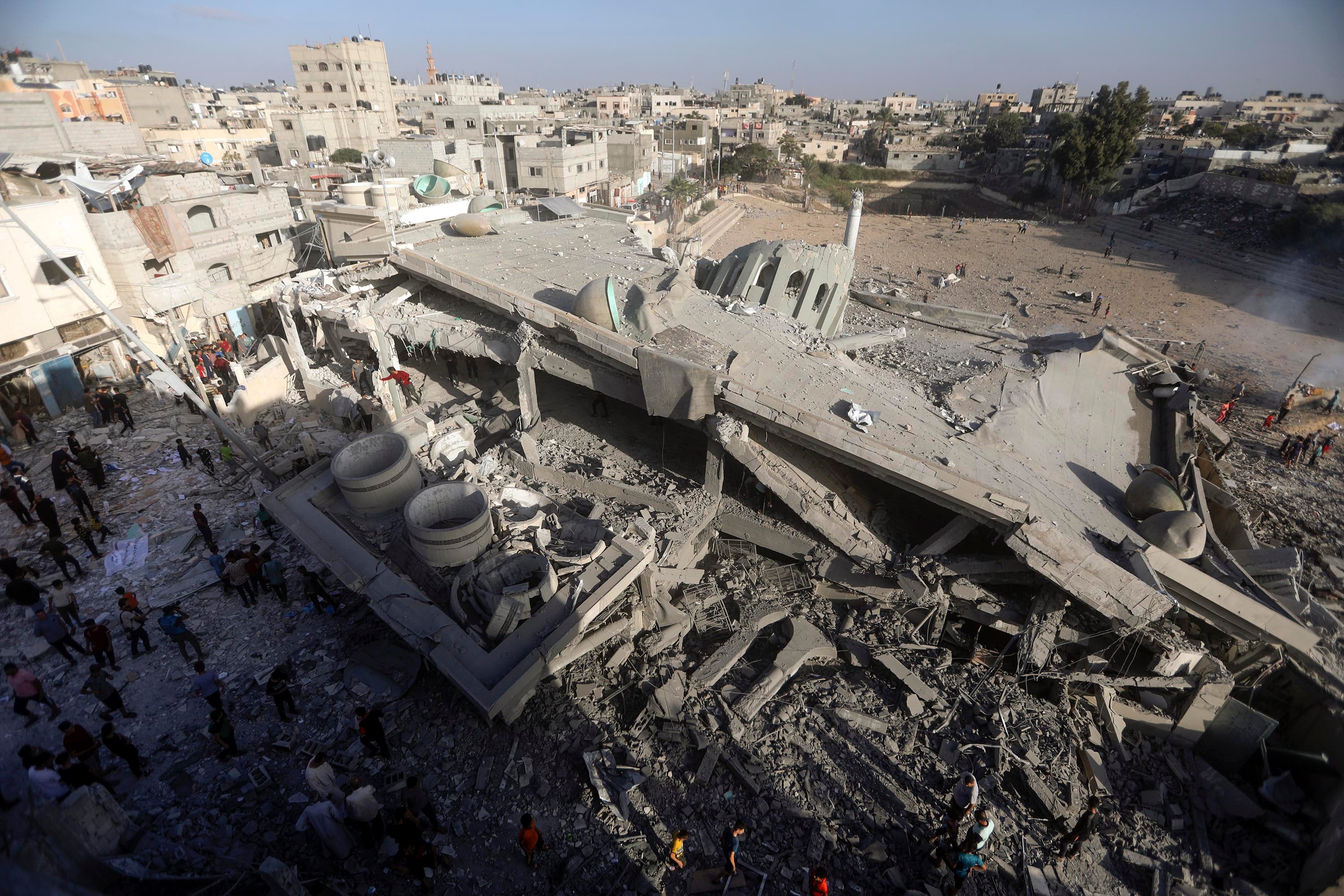 Palestinians inspect the damage of a destroyed mosque following an Israeli airstrike in Khan Younis refugee camp, southern Gaza Strip
