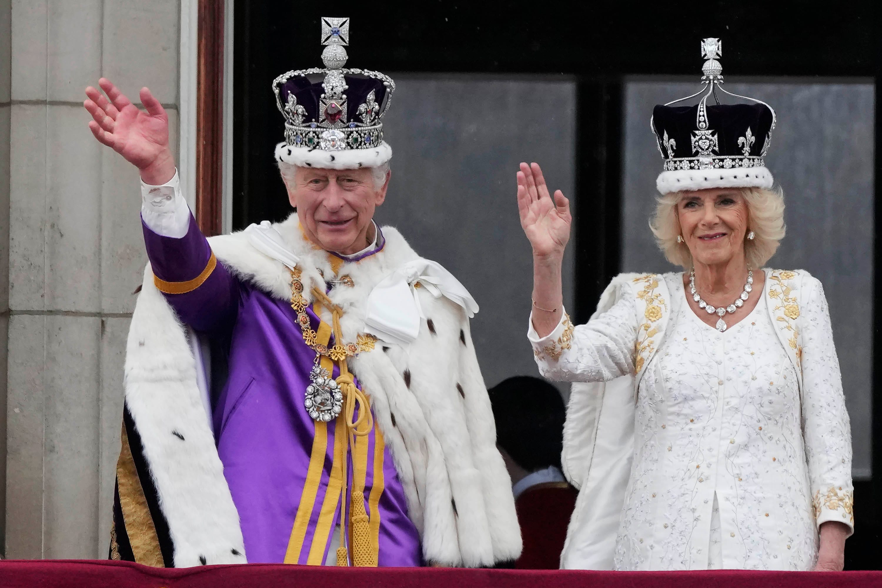 Britain's King Charles III and Queen Camilla wave to the crowds from the balcony of Buckingham Palace after the coronation ceremony