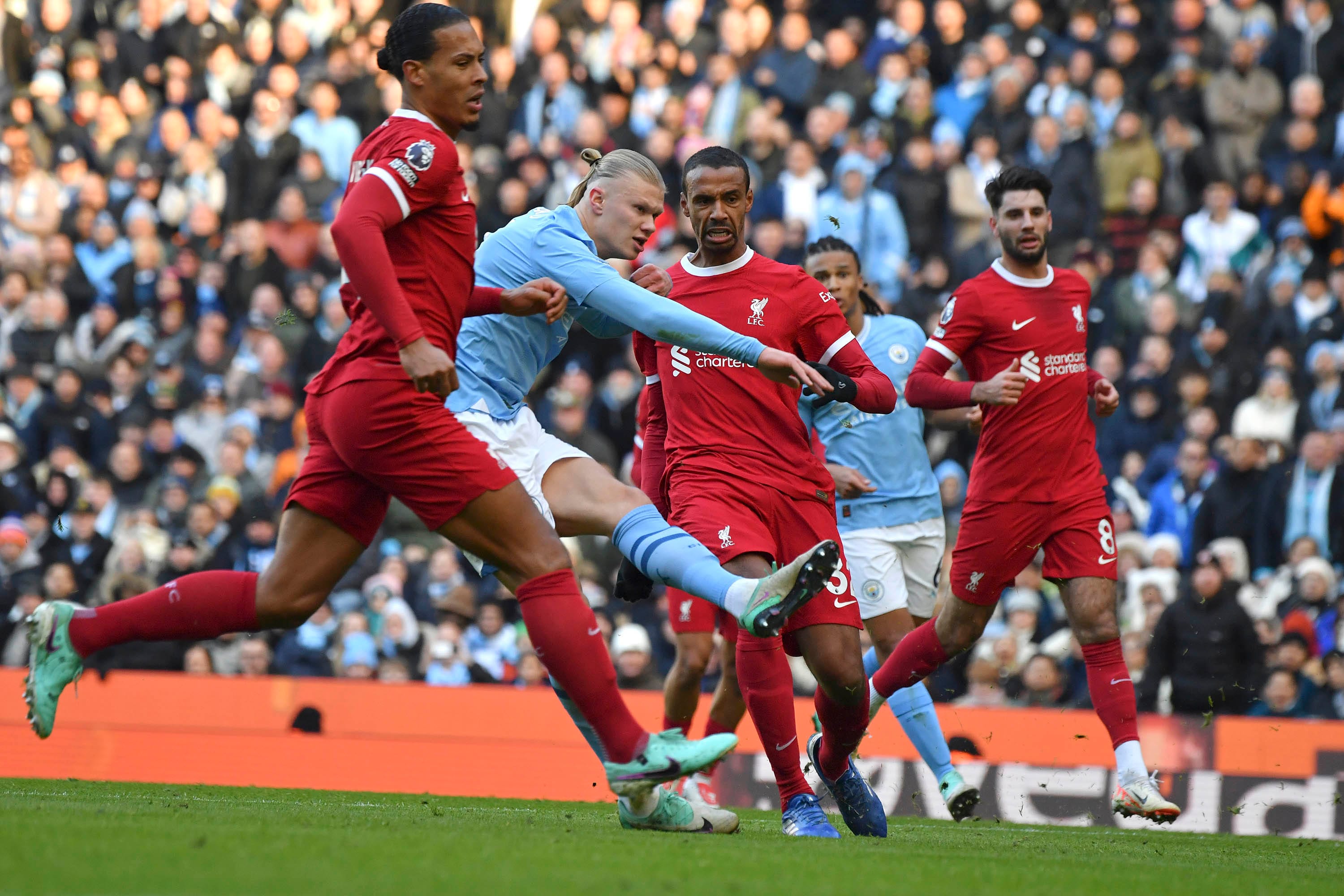 Manchester City's Erling Haaland scores his side's opening goal during the English Premier League soccer match between Manchester City and Liverpool